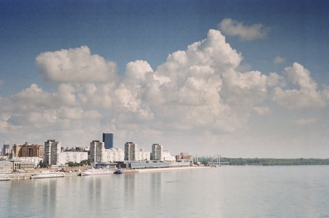a large body of water with a city in the background,