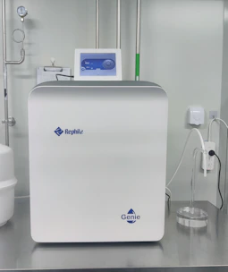 A sleek reverse osmosis water purifier unit with a transparent casing showing internal filters.