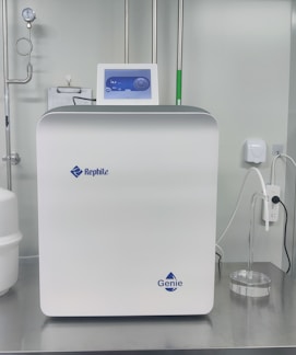 Close-up of a sleek water purifier unit with clear water flowing.