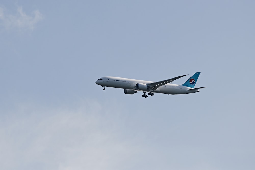 a large passenger jet flying through a blue sky