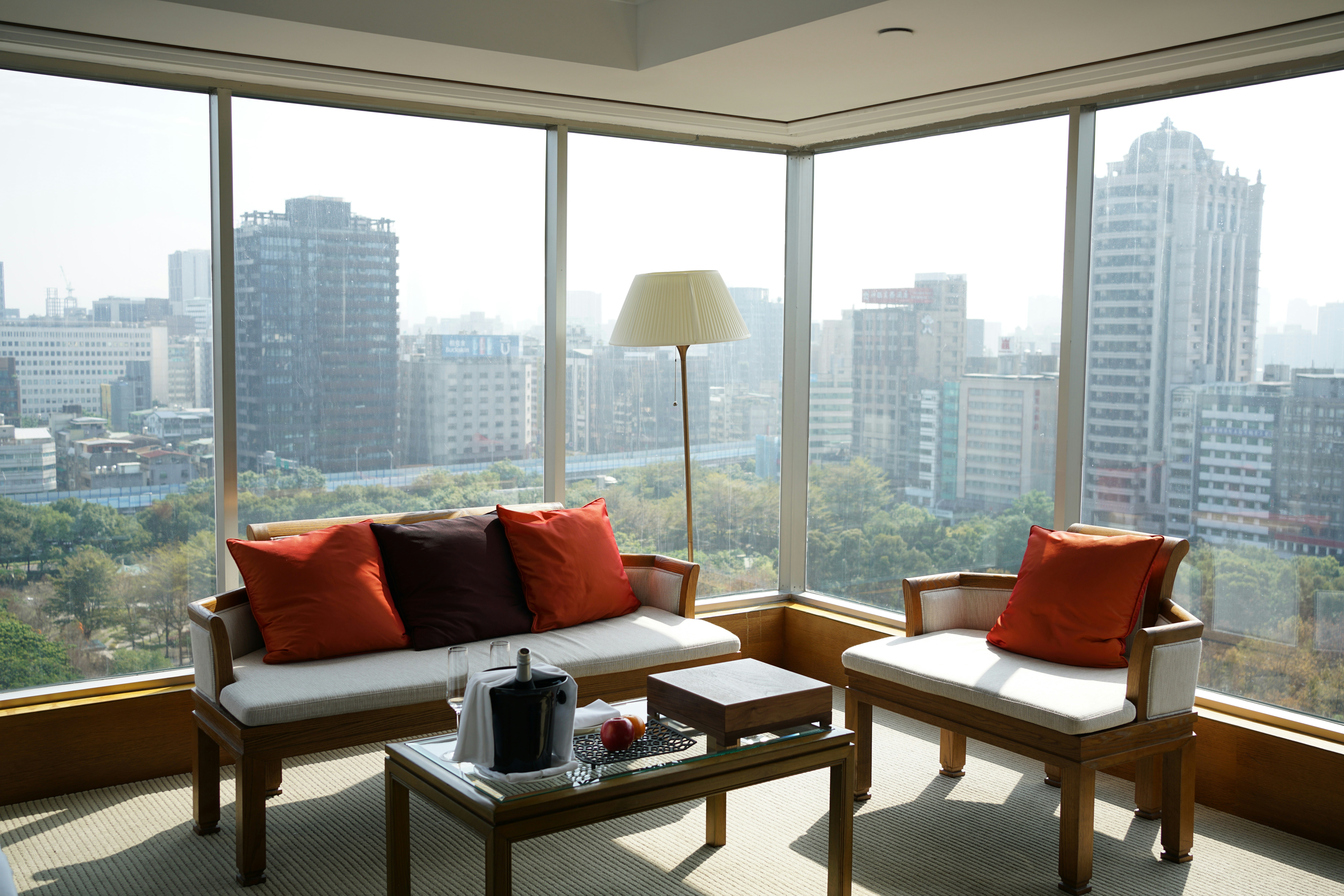 minimalist living room with furniture arranged to face a large window overlooking the city - city apartment view