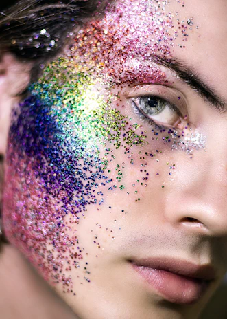 Artistic makeup featuring glitter and creative face painting for a special event.