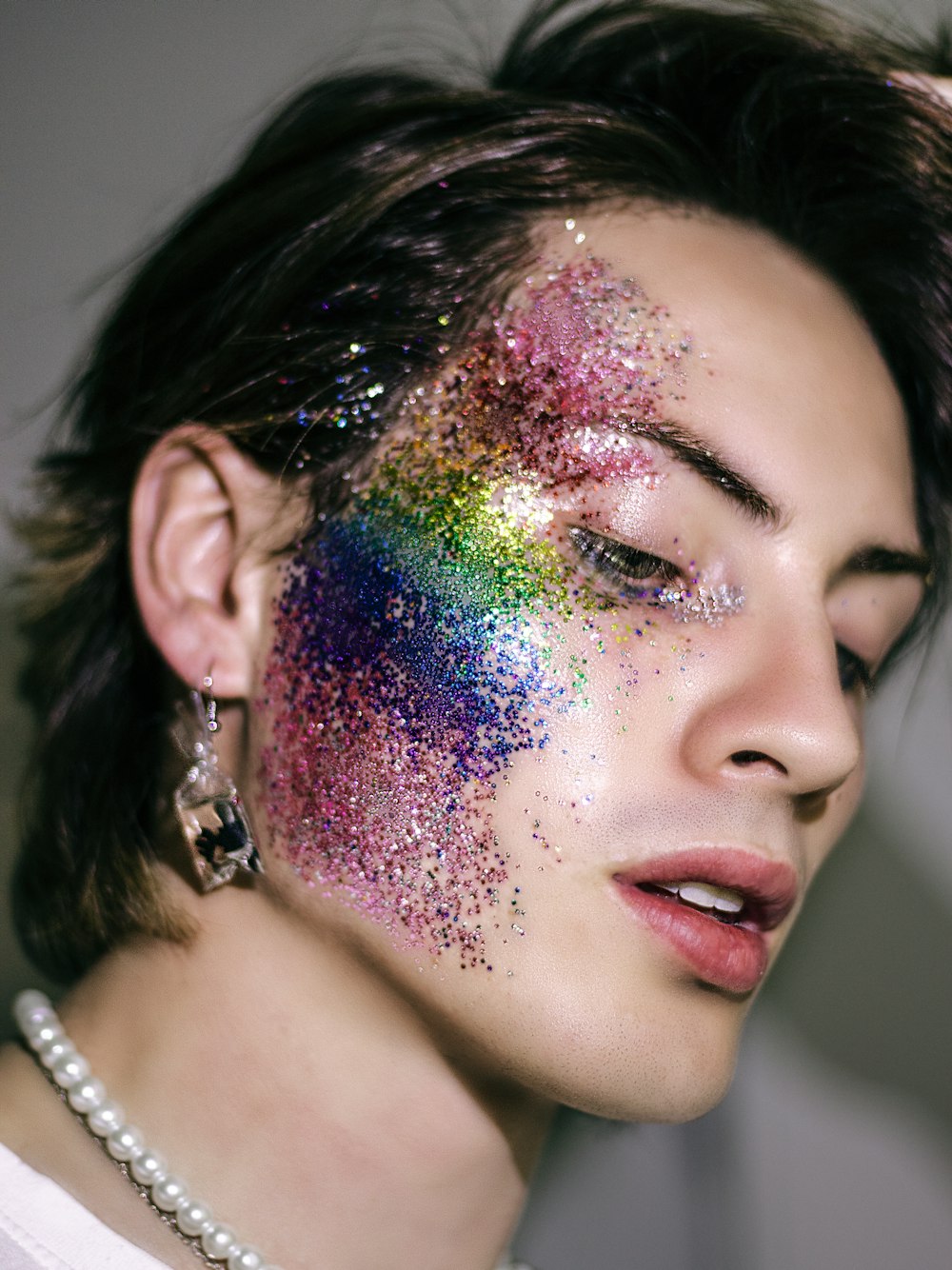 a man with his face covered in glitter