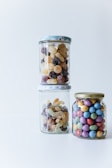 Close-up of colorful gourmet candies arranged in elegant glass jars.