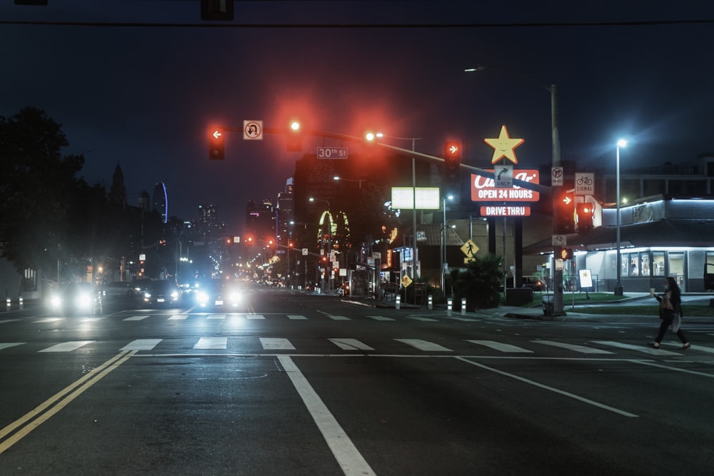 a city street at night with traffic lights