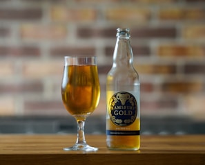 A selection of local ales served in rustic glasses, set against the backdrop of the sea.