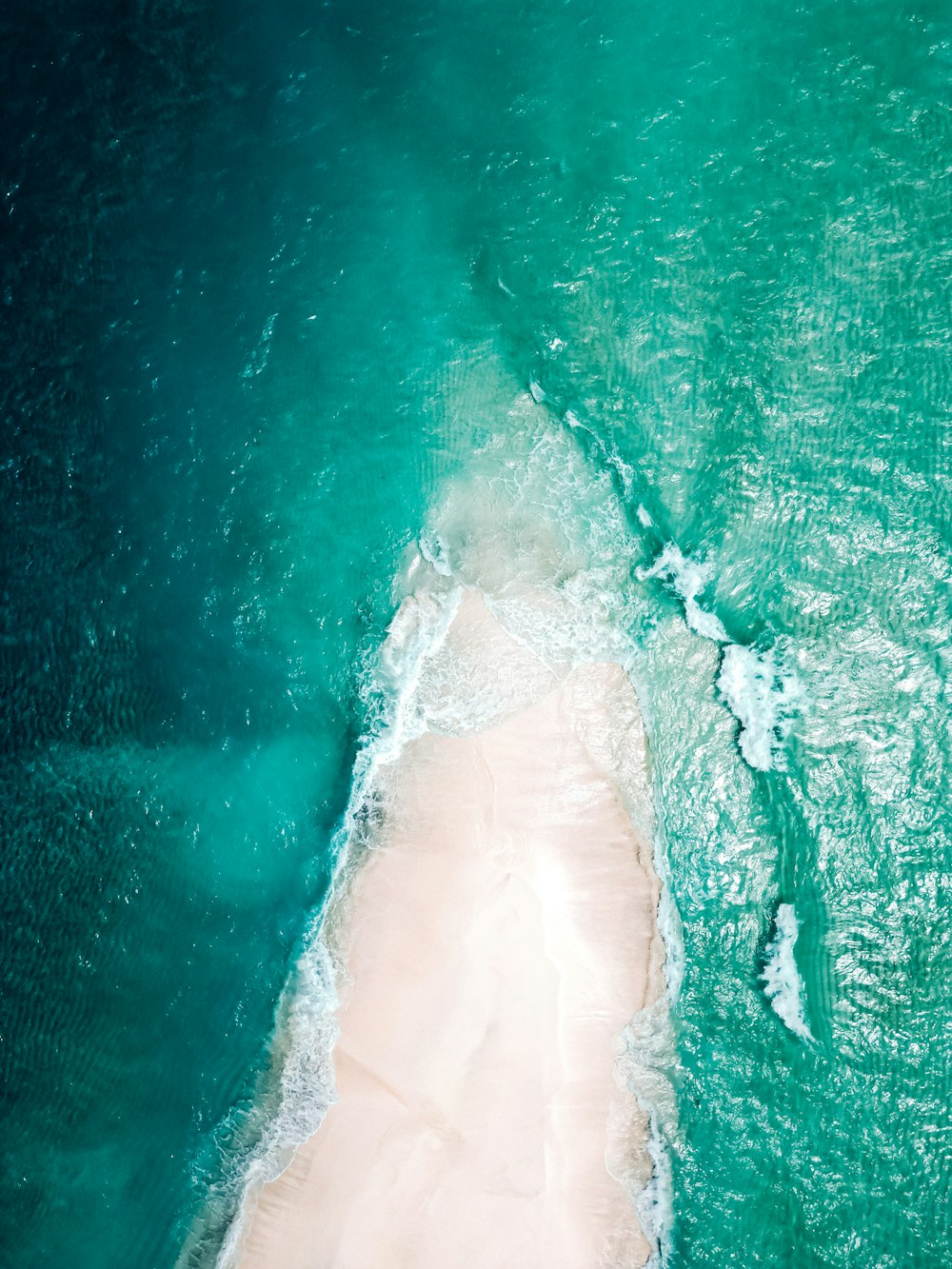 an aerial view of a sandy beach and ocean