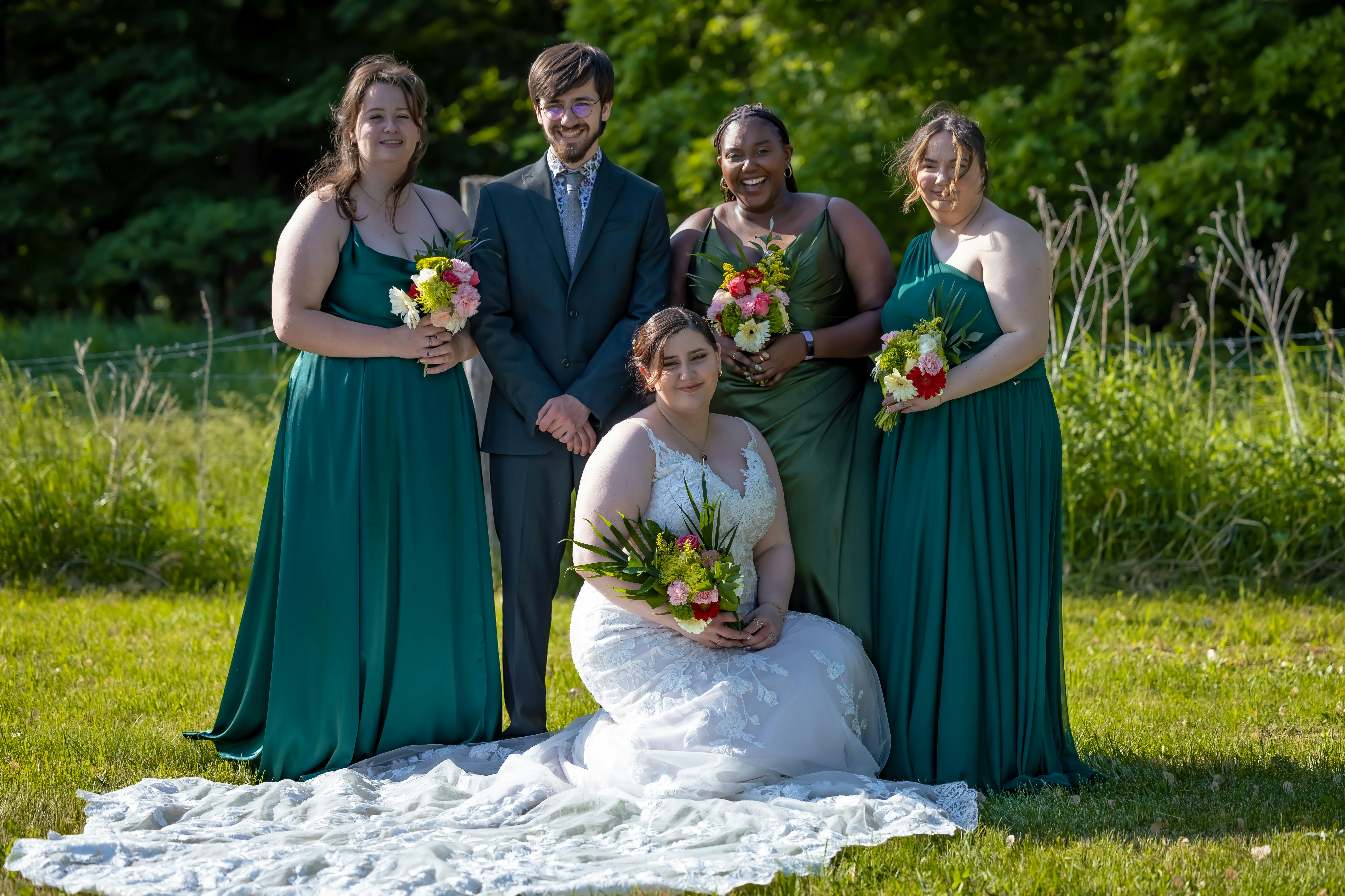 a group of people that are standing in the grass