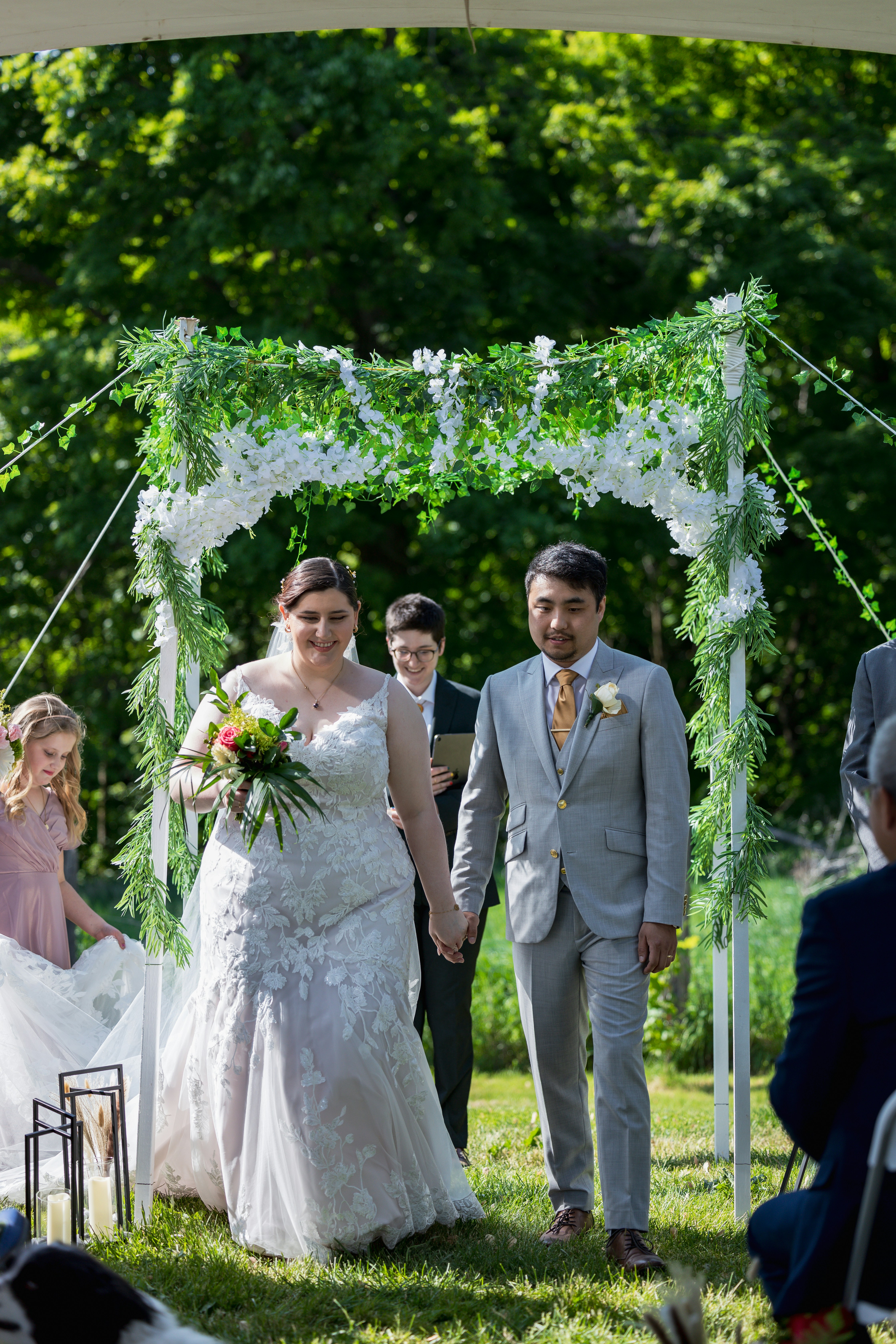 a bride and groom walking down the aisle