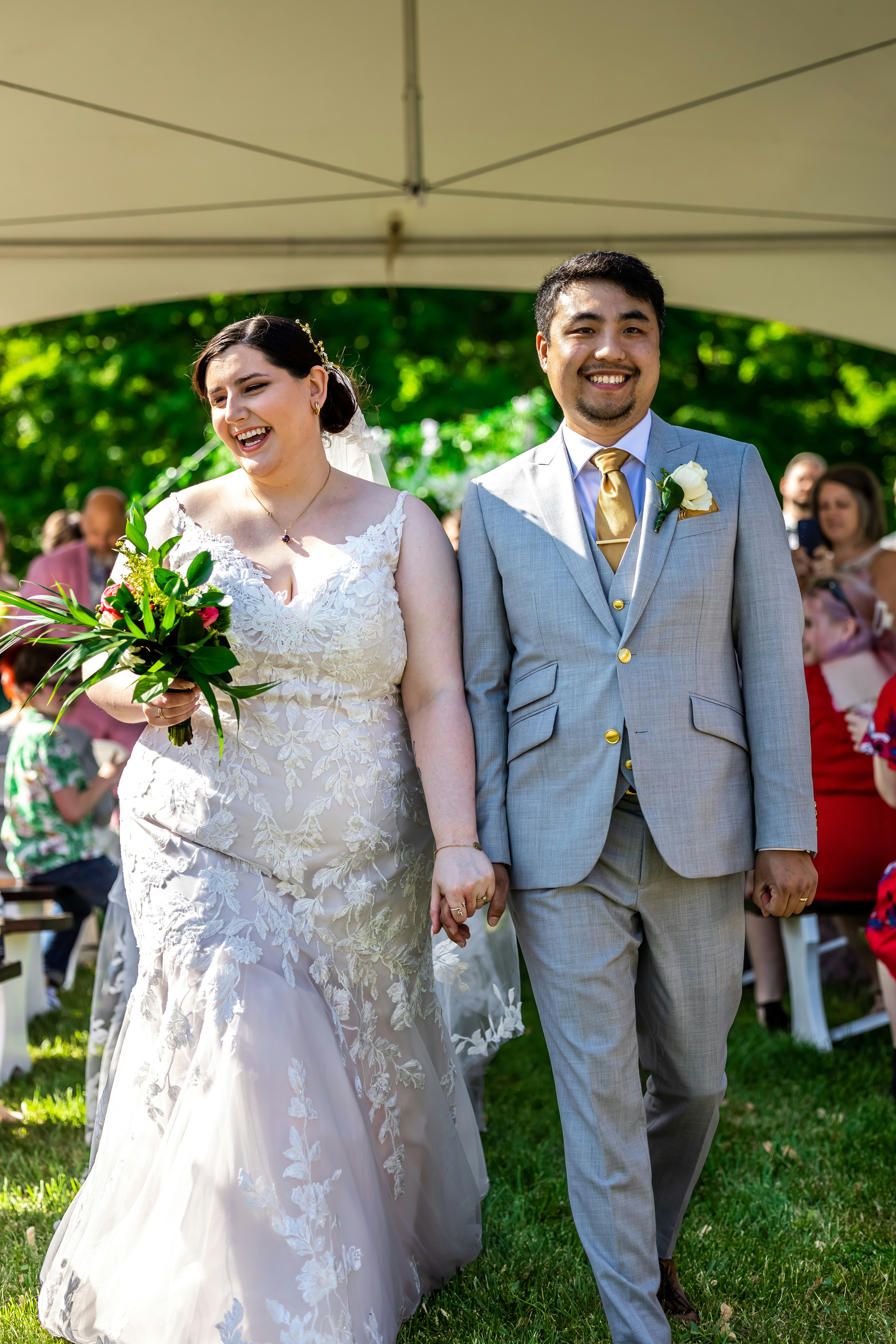 a bride and groom walking down the aisle