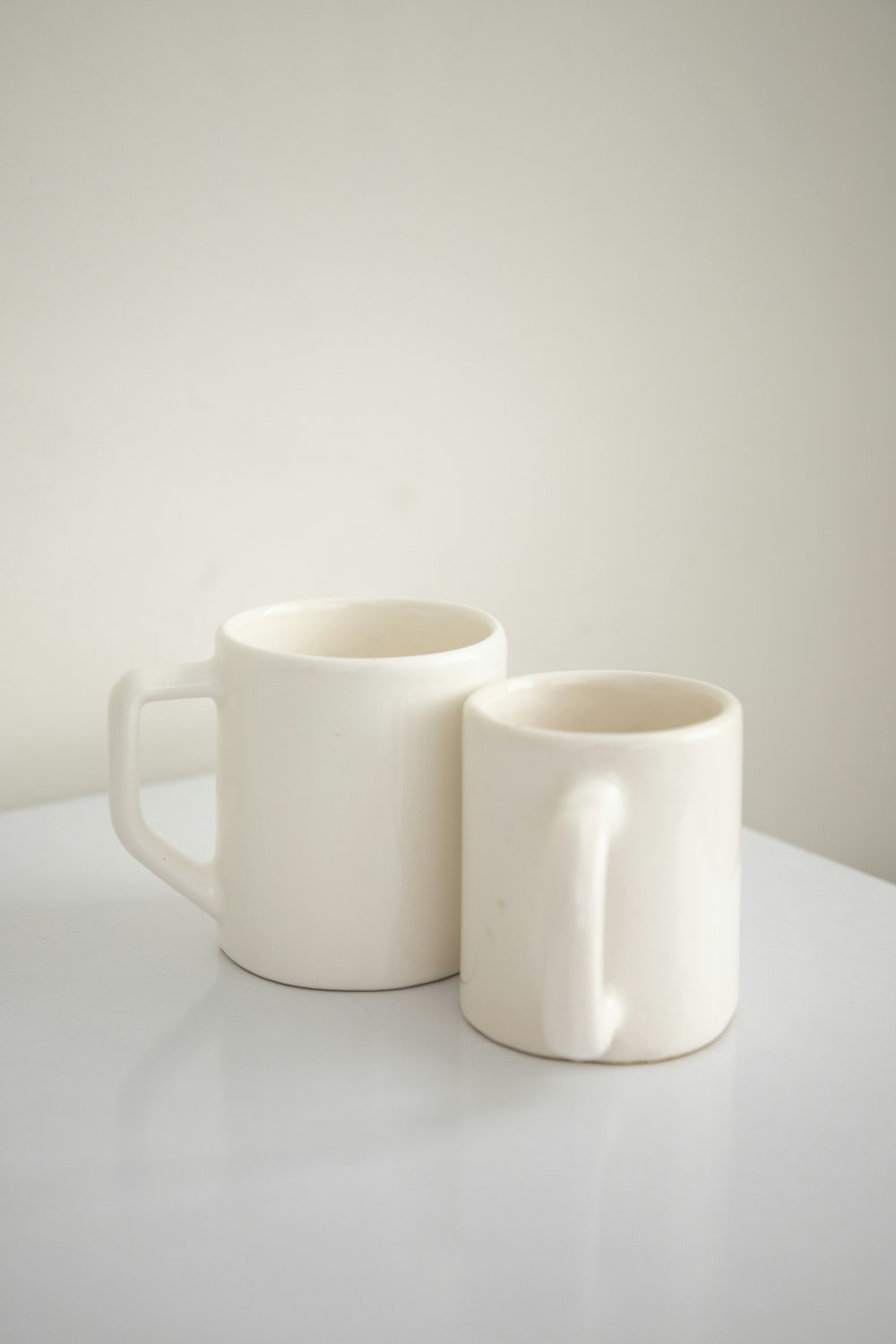 a couple of white mugs sitting on top of a table
