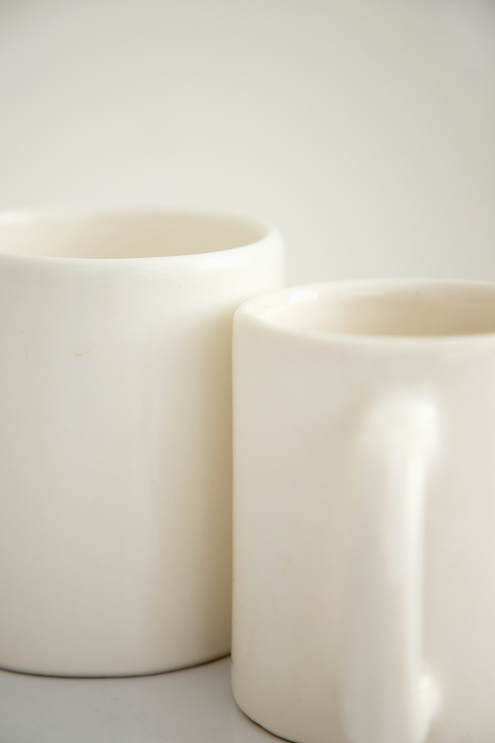 a couple of white mugs sitting on top of a table