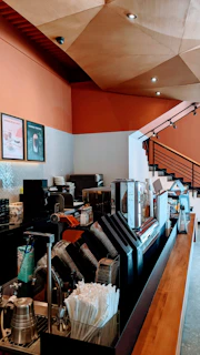 A modern coffee shop interior with wooden counters and ceramic walls.