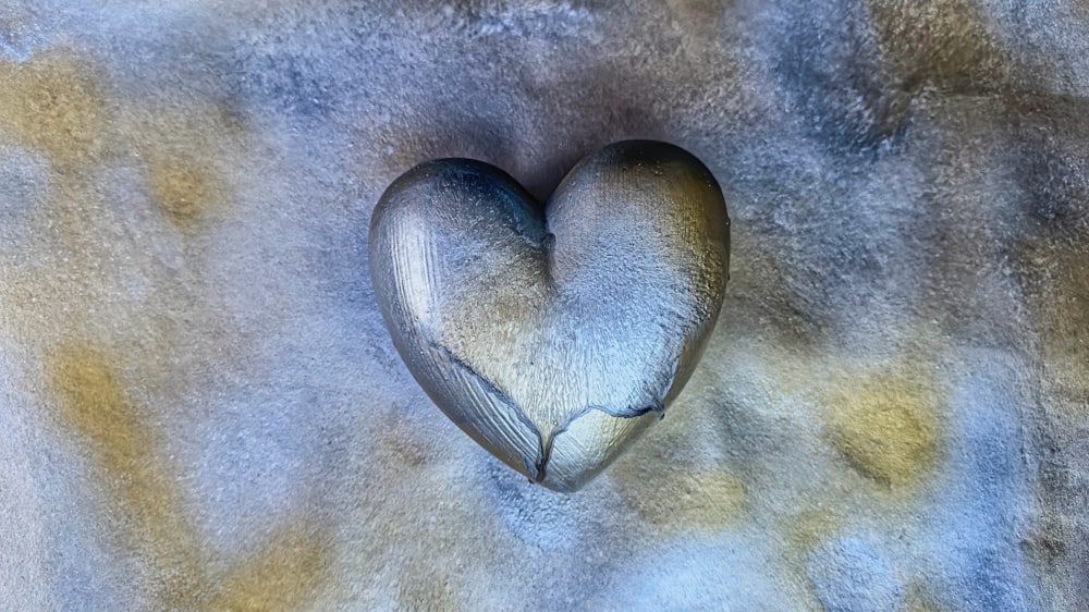 a heart shaped object on a gray background