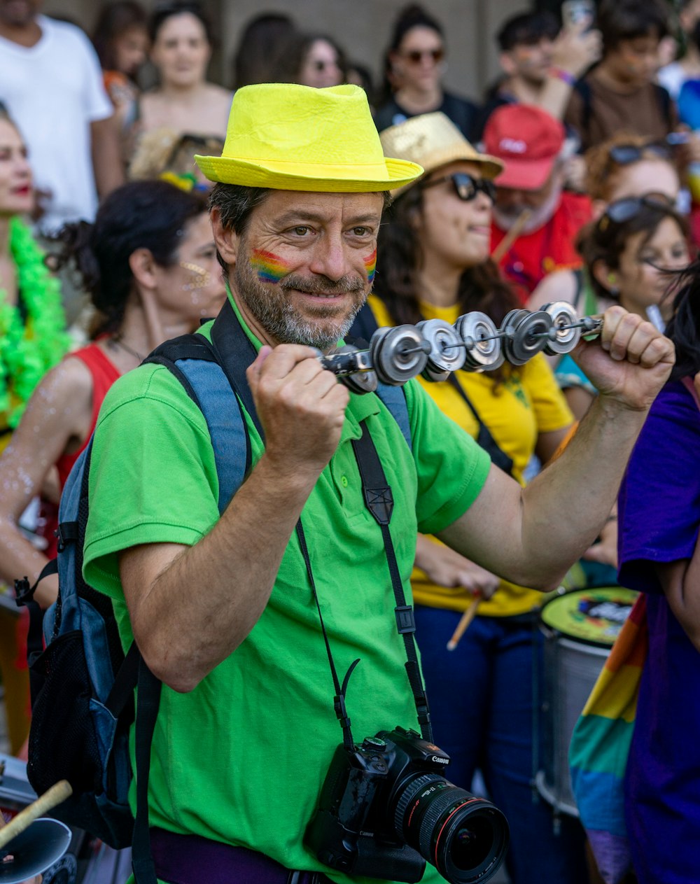 a man in a yellow hat is holding a camera