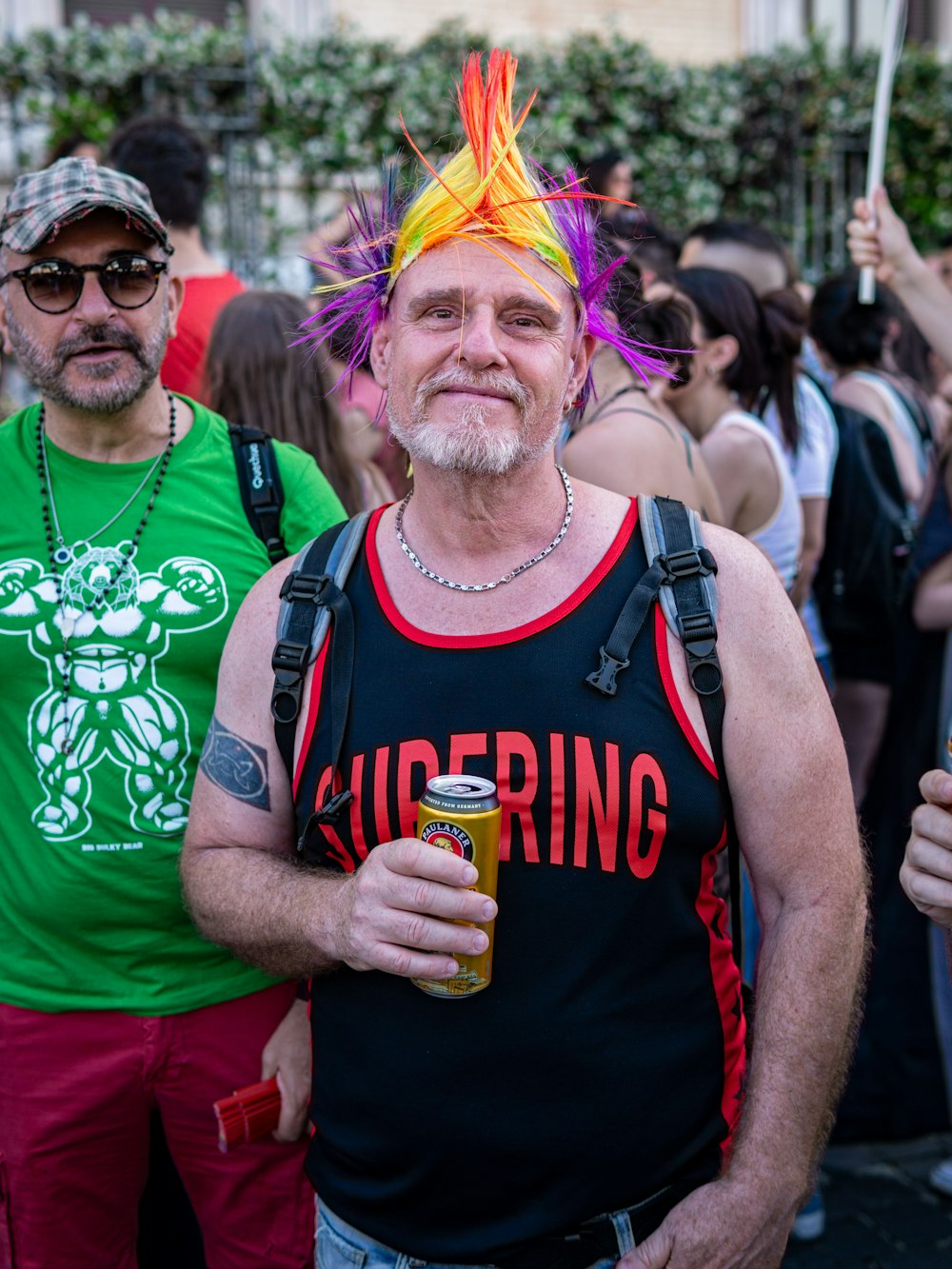 a man with a mohawk standing next to another man