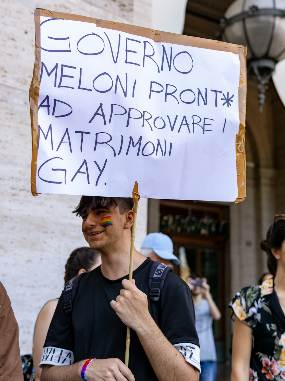 a man holding a sign with a message on it