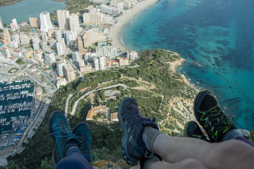 a person standing on top of a cliff overlooking a city