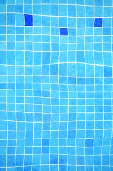 a blue tiled swimming pool with blue tiles