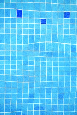 a blue tiled swimming pool with blue tiles