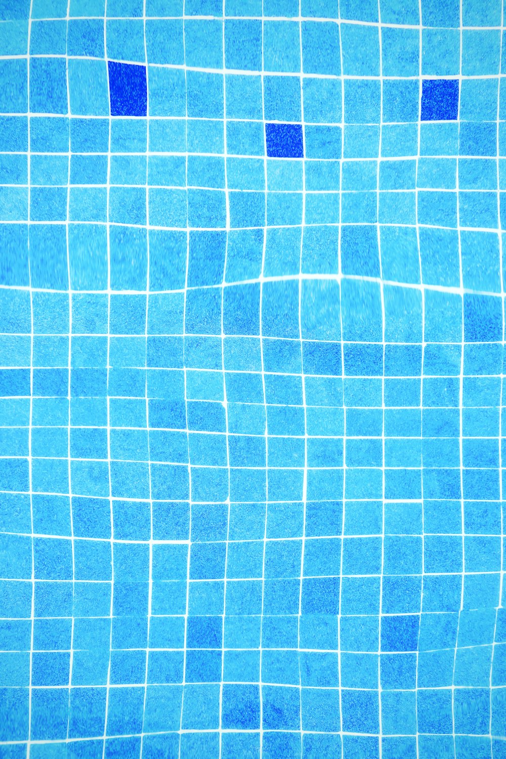 a blue tiled swimming pool with blue tiles
