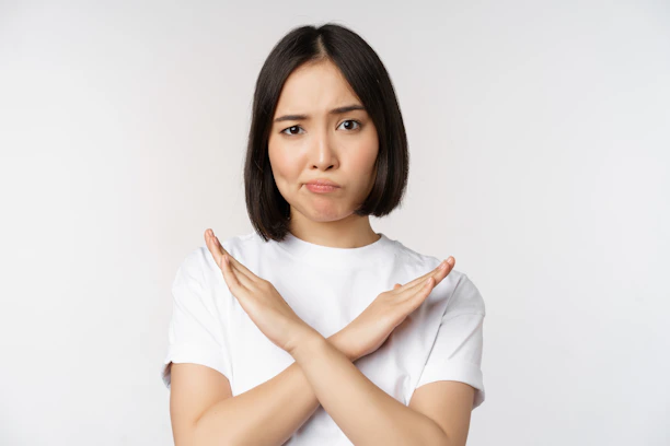 a woman with her hands folded over her chest