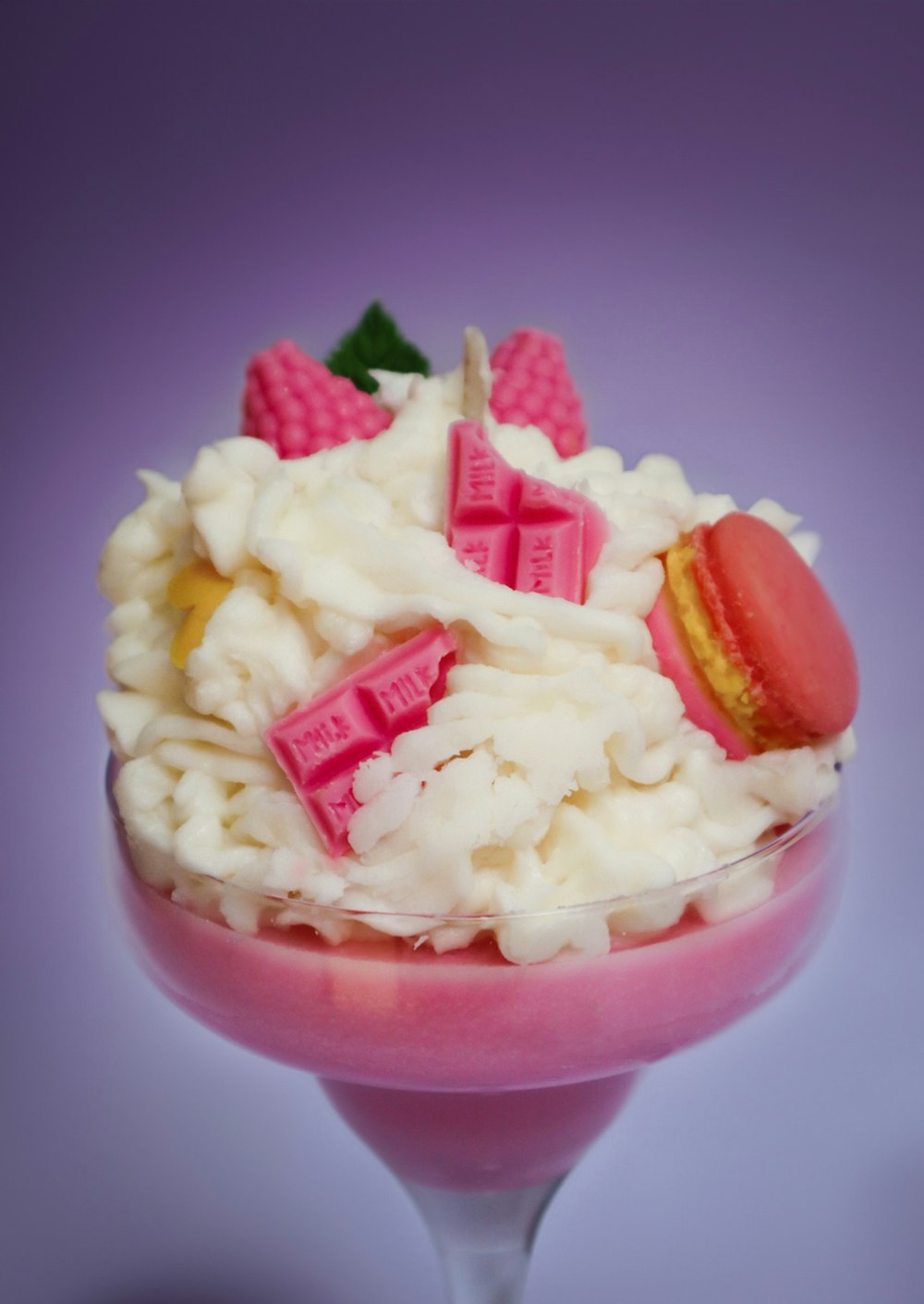a dessert in a glass with a pink base