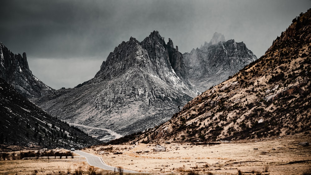 a mountain range with a road in the foreground