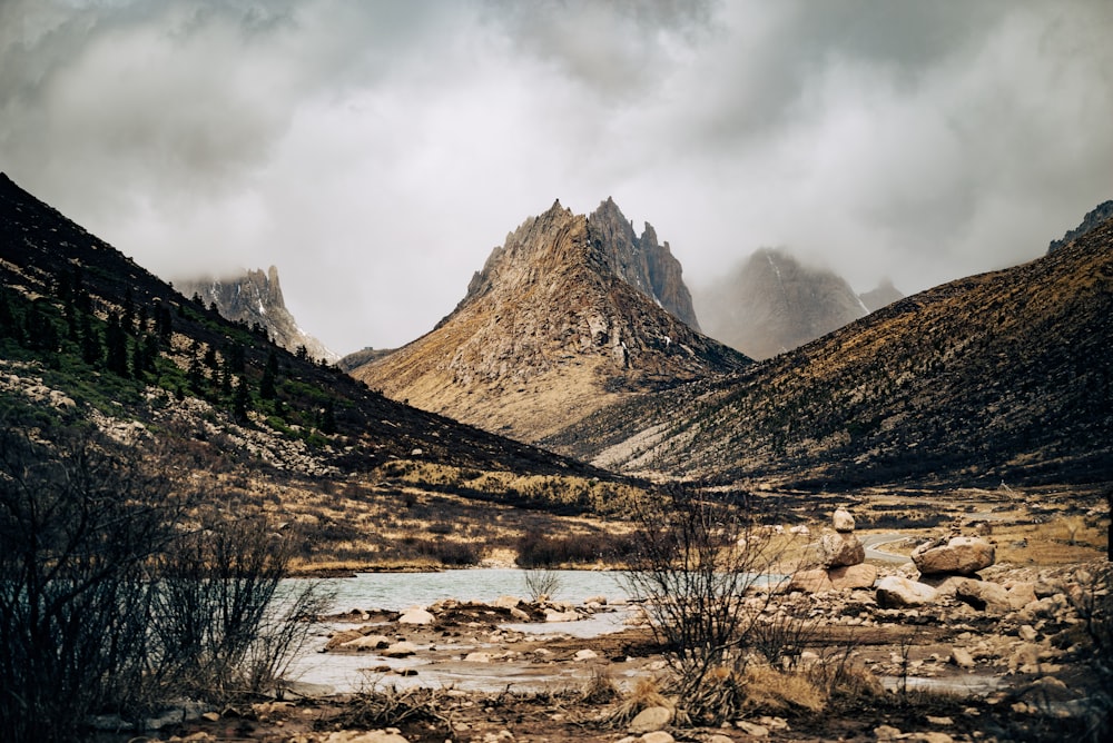 a mountain range with a river in the foreground