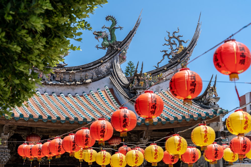 red and yellow lanterns hanging from a roof