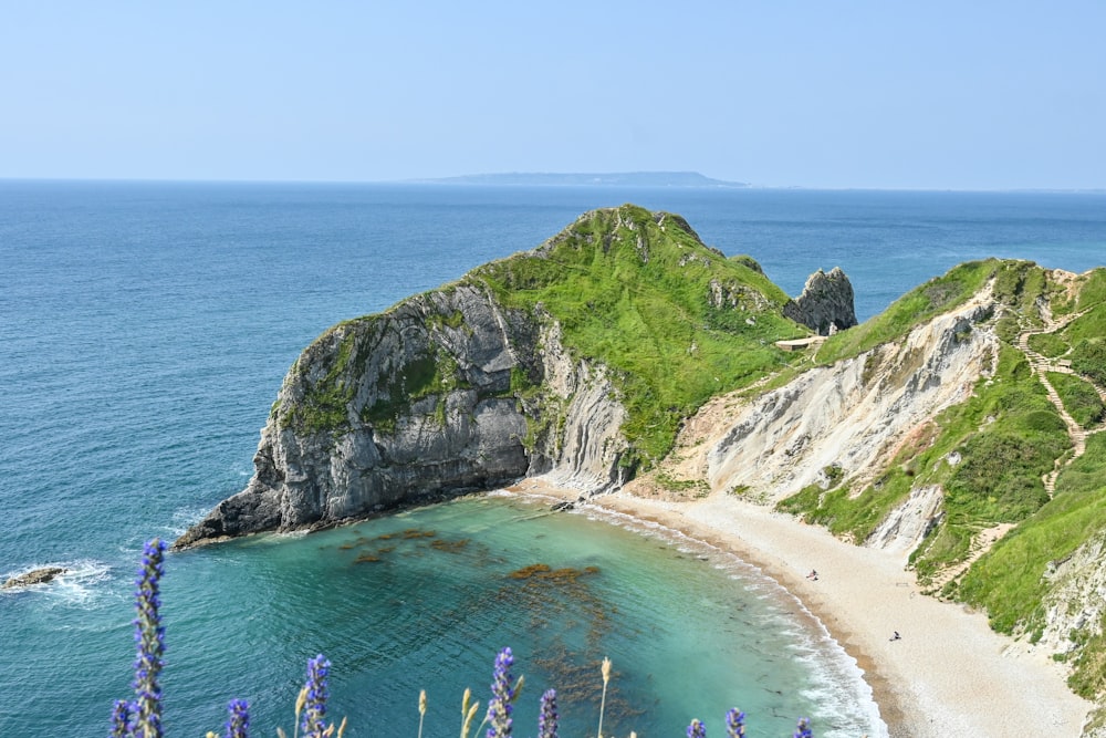 a view of a beach from a hill overlooking the ocean