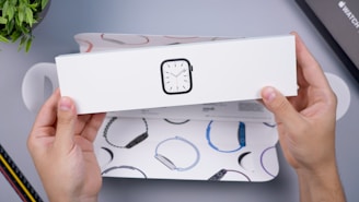 Close-up of hands holding a popular gadget with vibrant packaging.