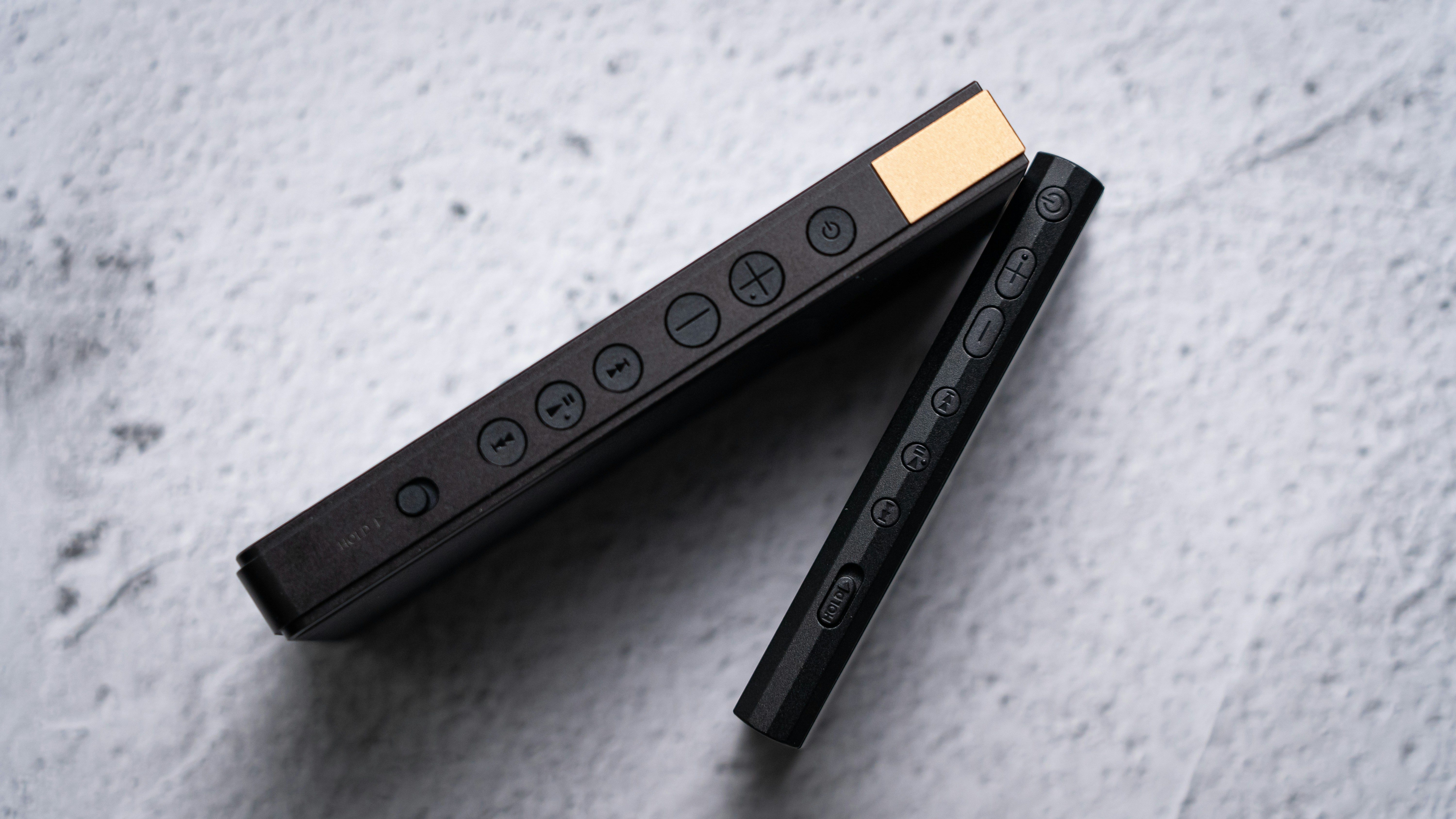 a pair of black pencils sitting on top of each other