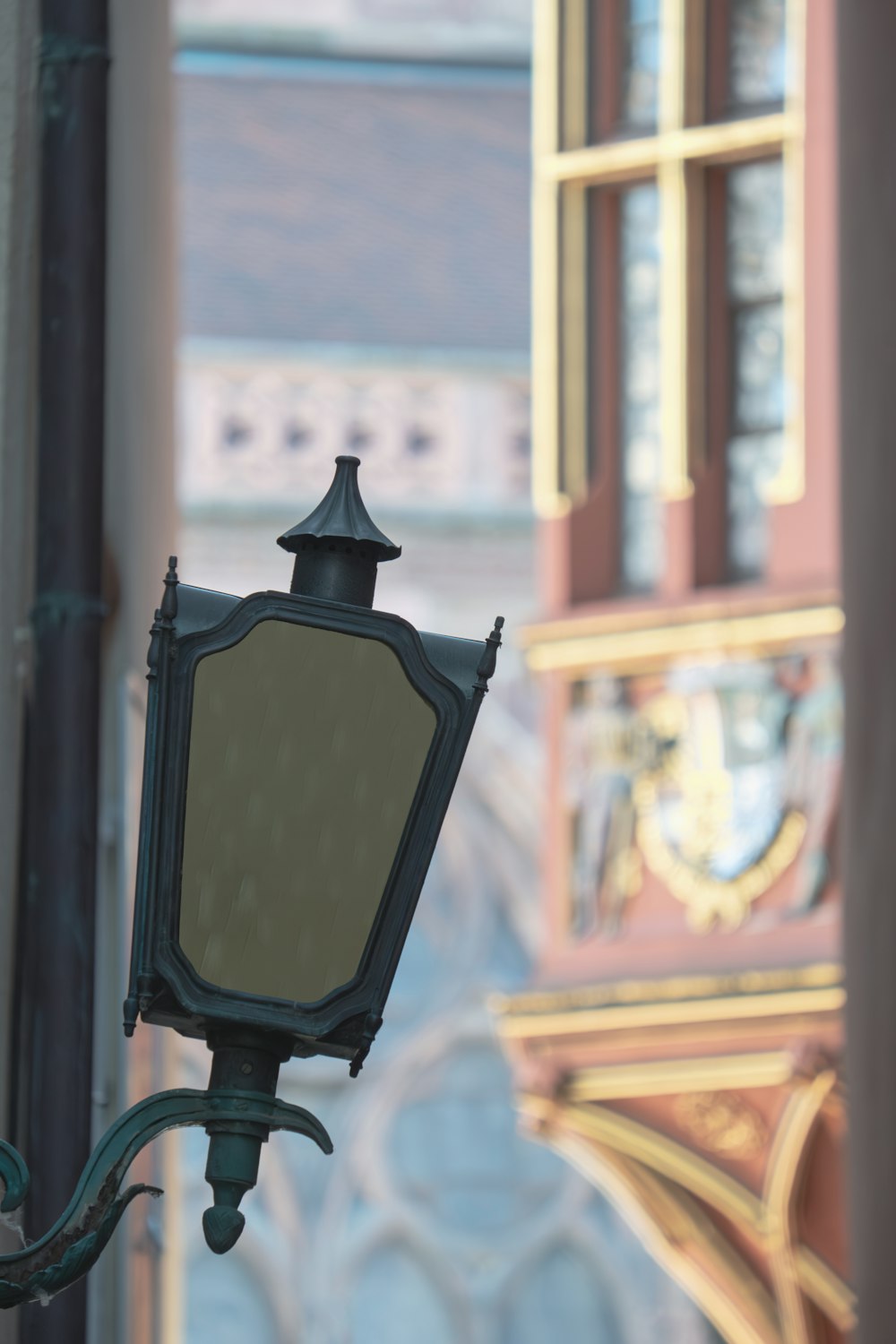 a lamp post with a mirror on top of it