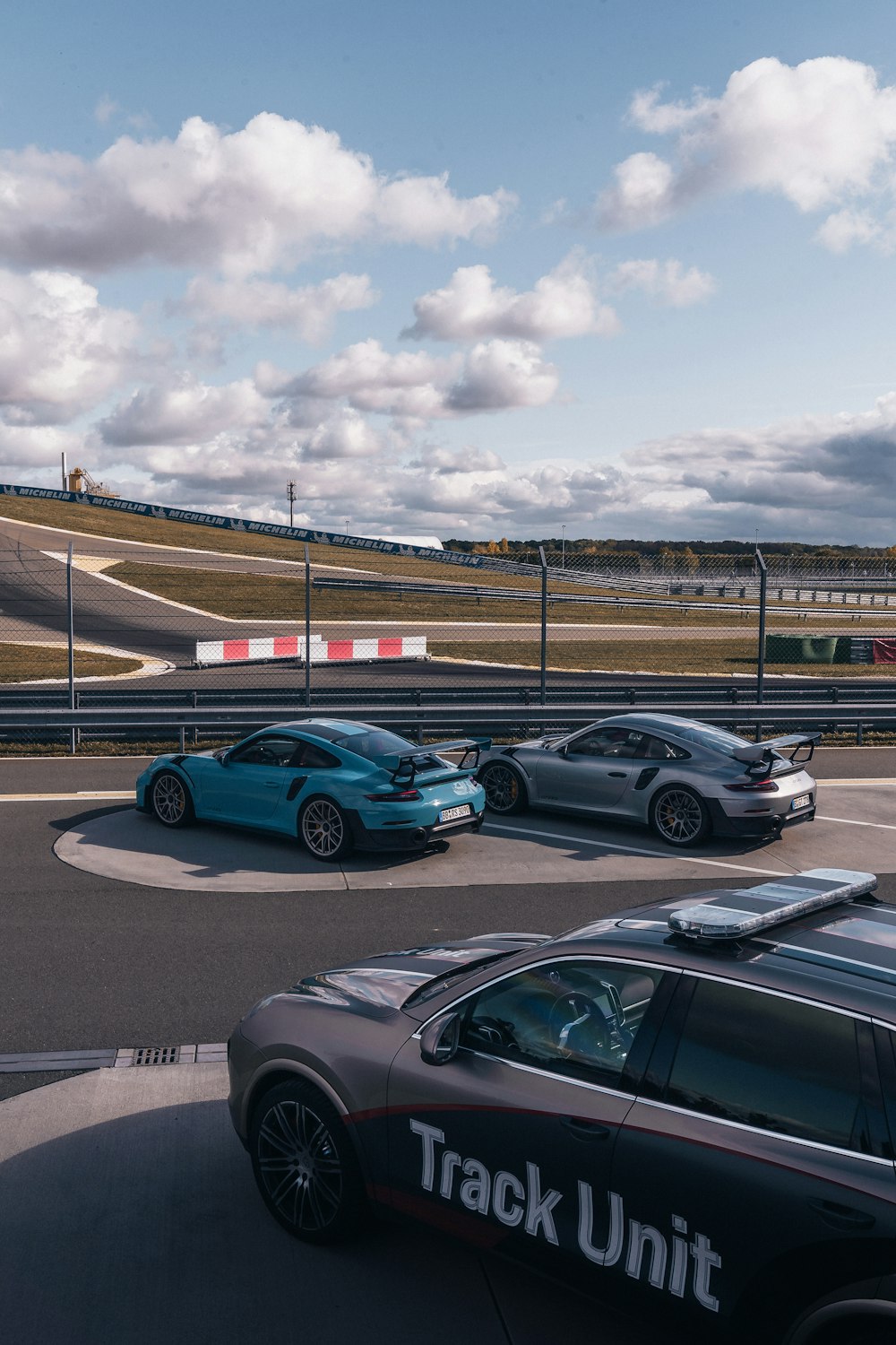 a group of cars driving around a track