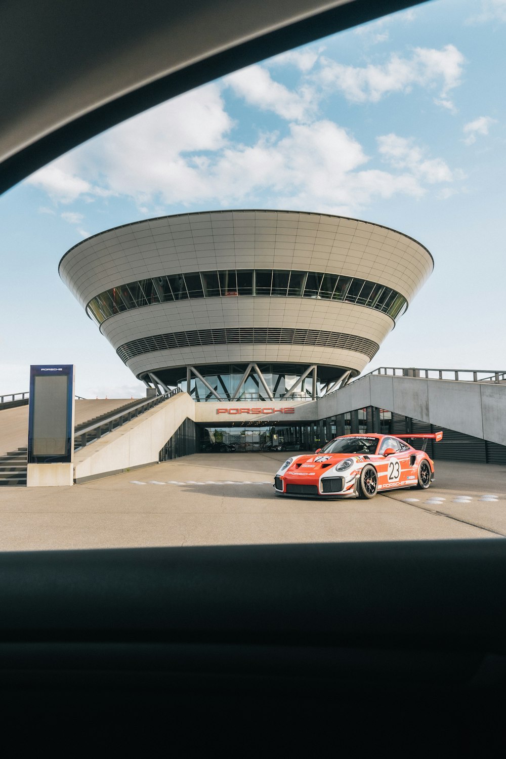 two cars parked in front of a large building