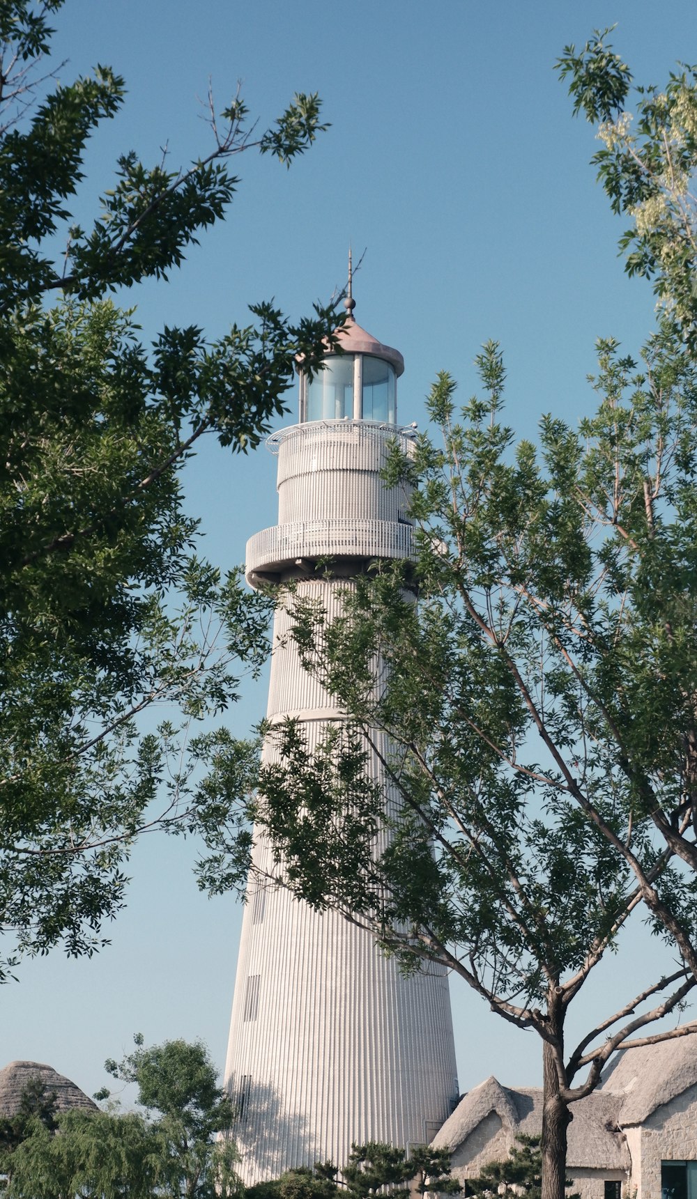 a tall white tower with a light on top of it