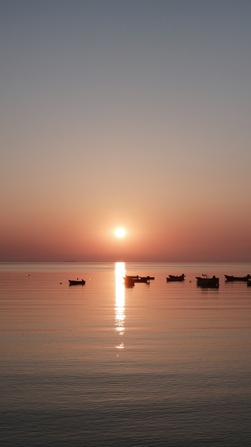 a group of boats floating on top of a large body of water