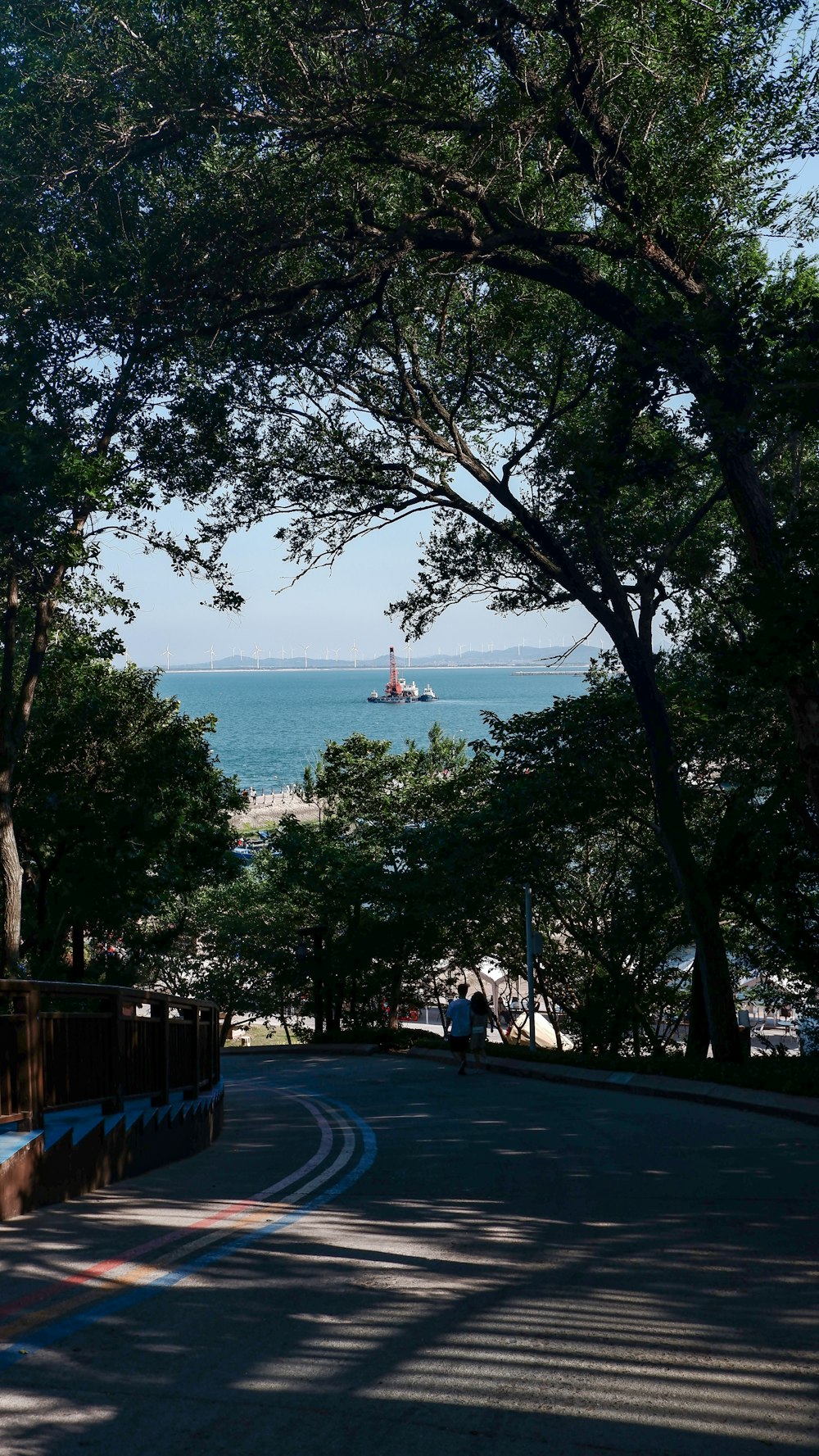 a view of the ocean from a park bench