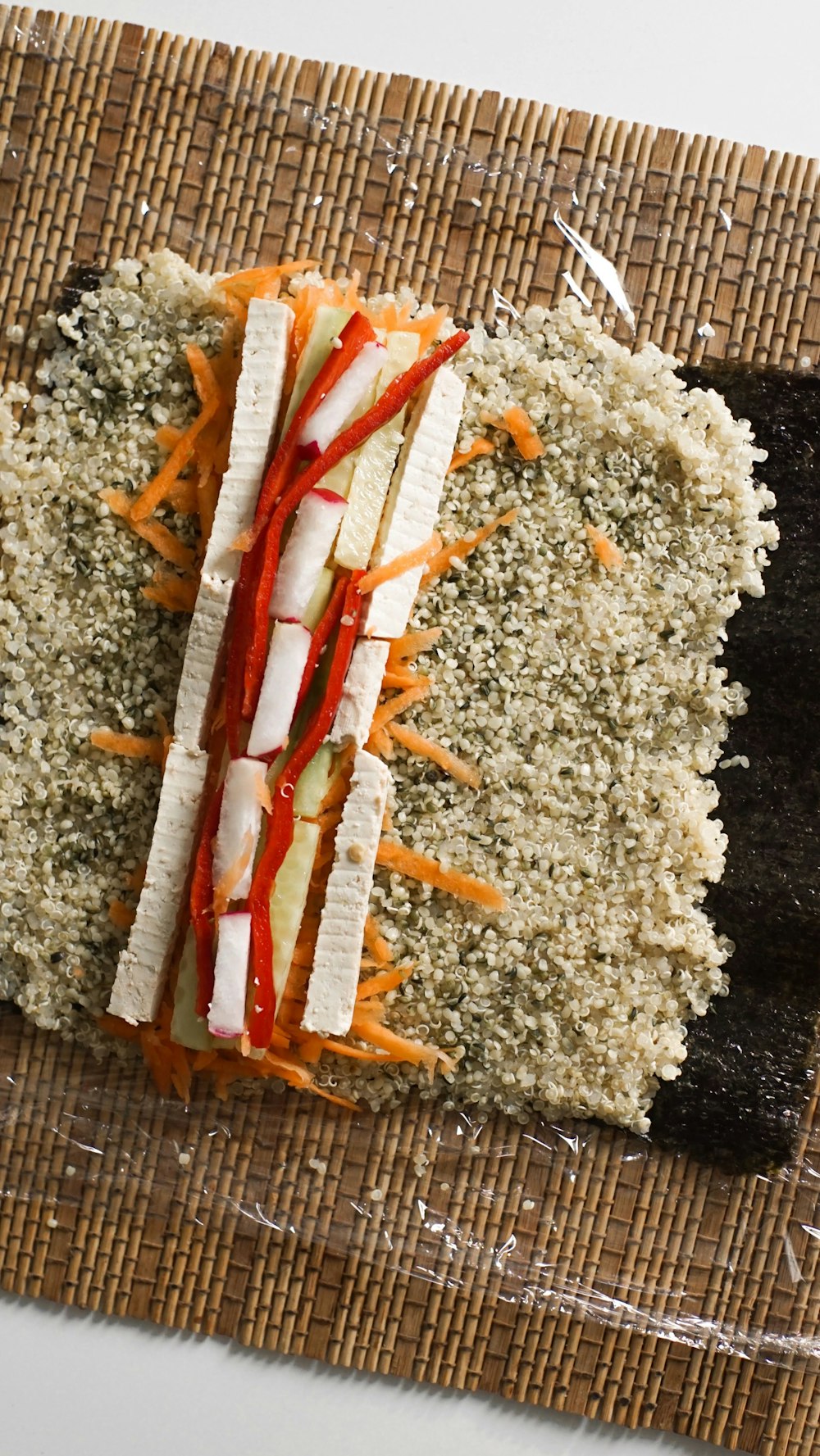 a sandwich with carrots, cheese, and lettuce