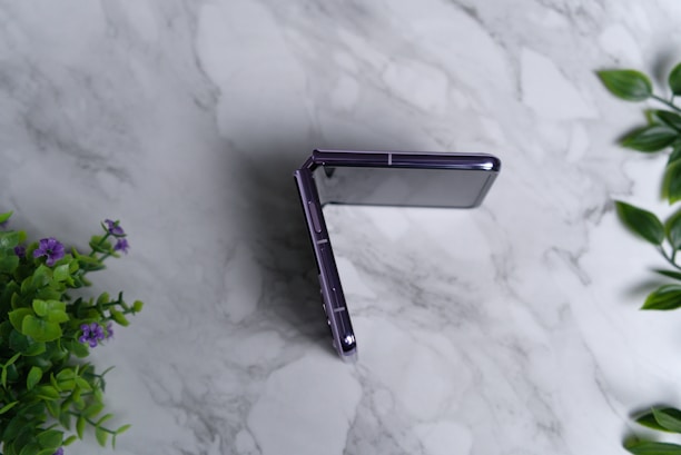 a close up of a cell phone on a marble surface
