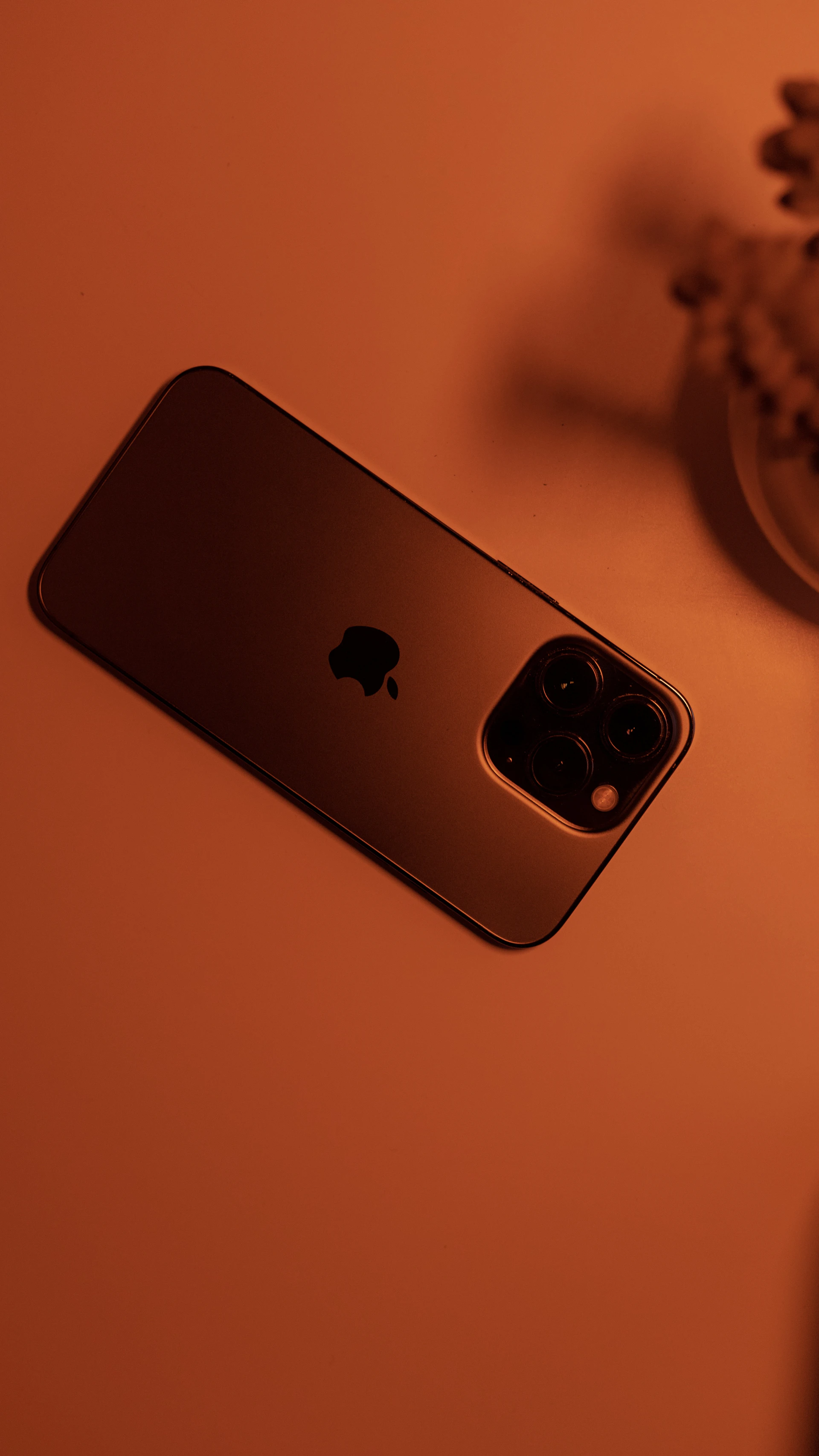 a gold iphone sitting on top of a table