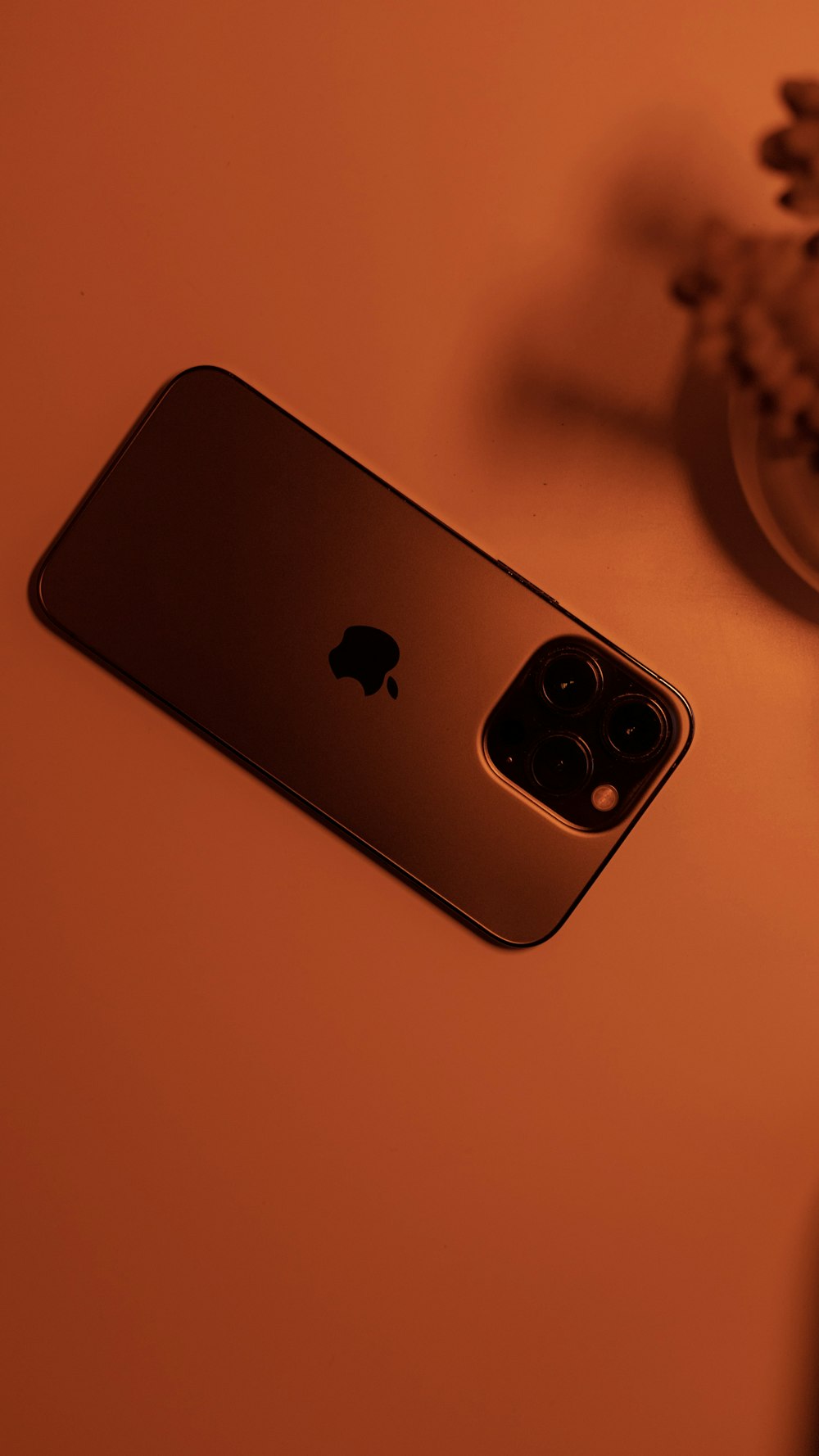 a gold iphone sitting on top of a table