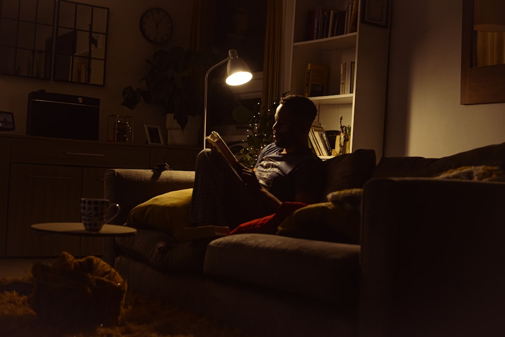 a person sitting on a couch in a dark room