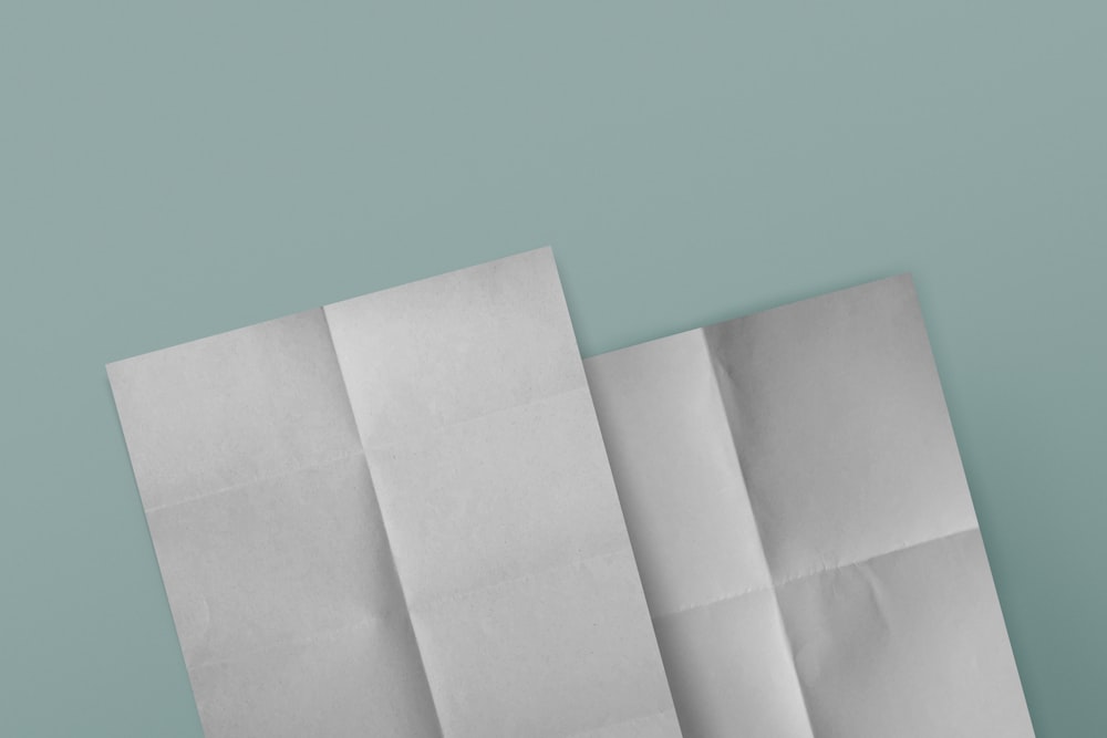 three pieces of white paper on a blue background