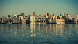 Traditional architecture and waterfront views in Sharjah at sunset.