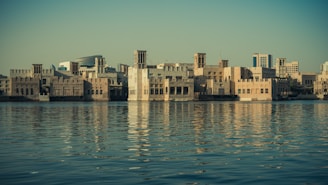 a large body of water with buildings in the background