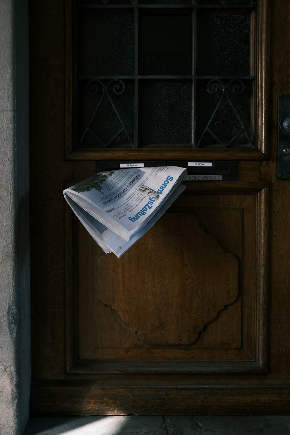 a newspaper sitting on top of a wooden door