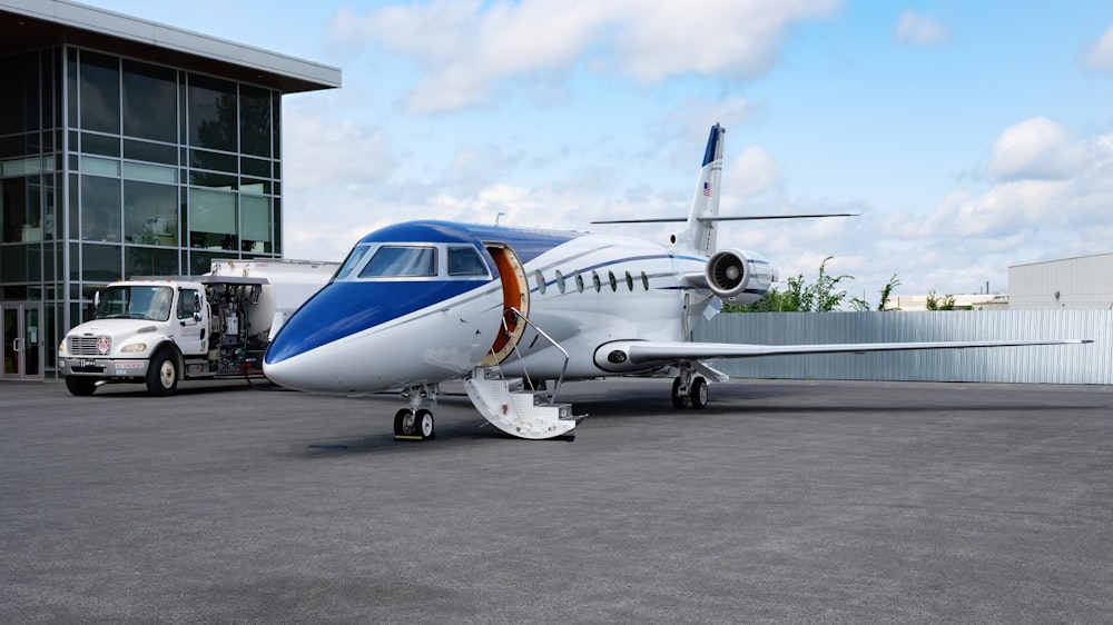 a small airplane parked in front of a building