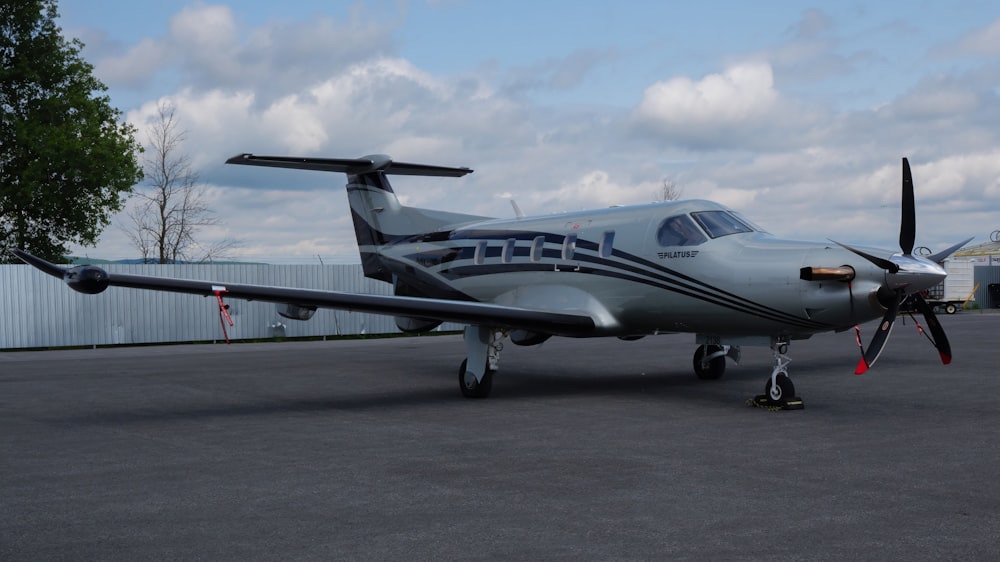 a small airplane sitting on top of an airport tarmac